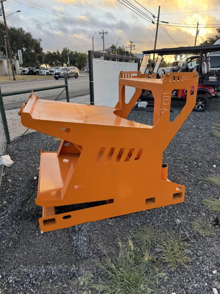 Orange steel workbench for industrial or workshop use at auction.