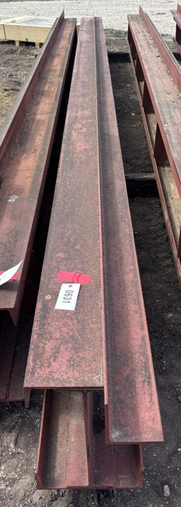 Rusty steel I-beams for sale at an auction event.