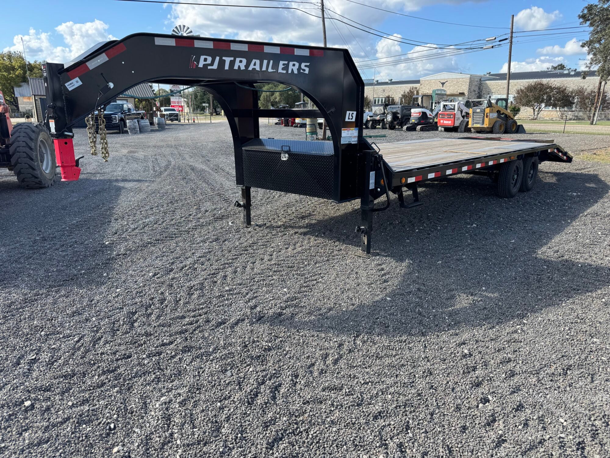 Flatbed trailer with gooseneck hitch and black powder-coated frame.