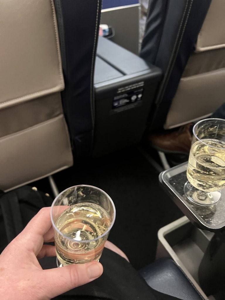 Champagne glasses on a flight, capturing a travel moment.
