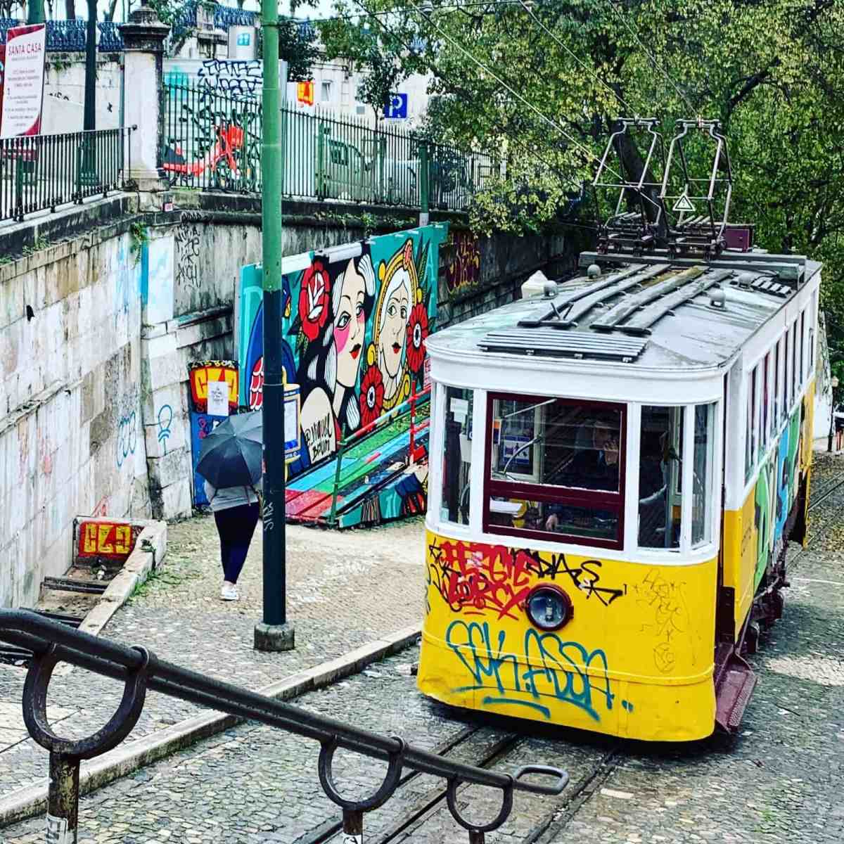 Tram in Montmartre with colorful graffiti murals and urban street art.