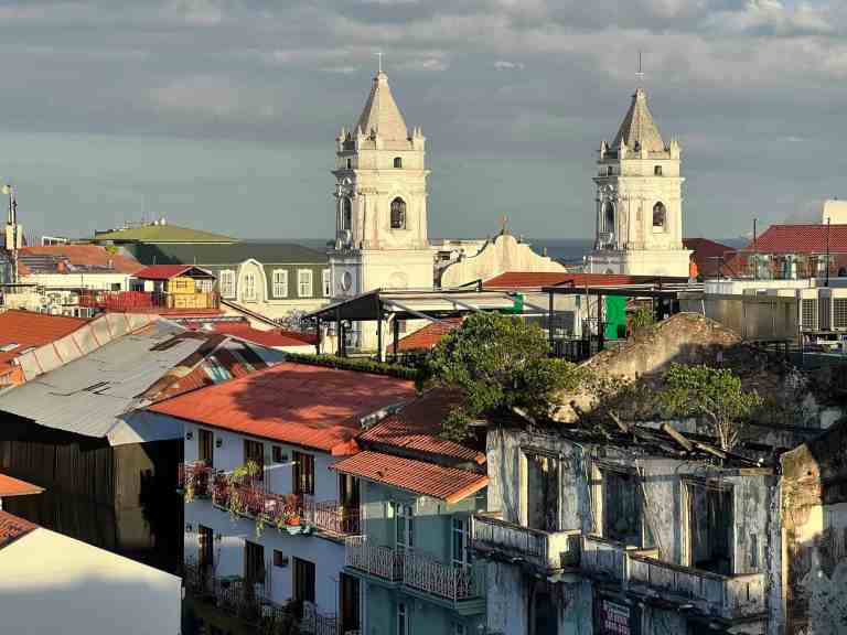 Historic cityscape with church towers and colorful rooftops in a travel destination.