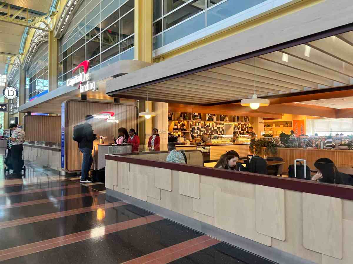 Airport lounge with travelers enjoying coffee and snacks.