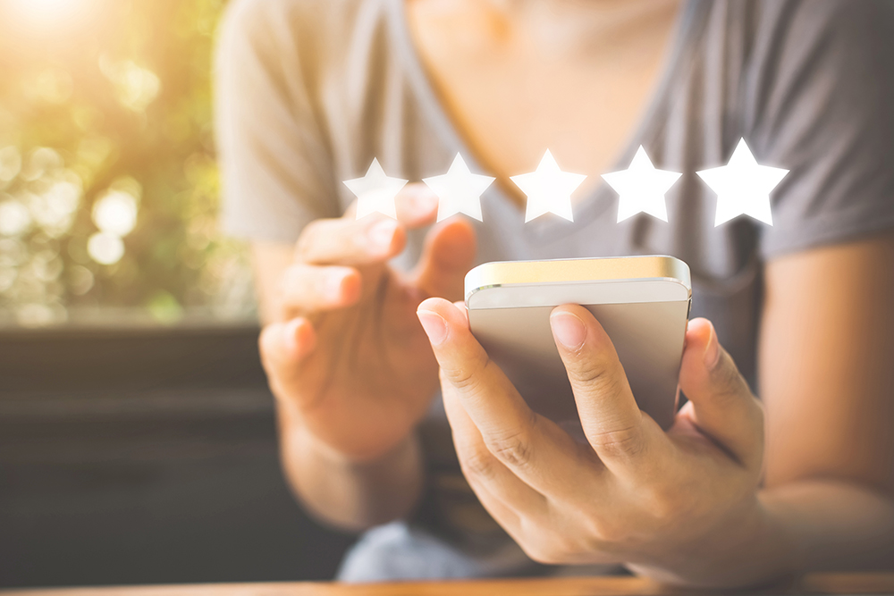 A satisfied customer leaving a positive review on Google or Facebook.