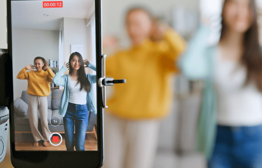 Two individuals collaborating to create engaging social media video TikTok content.