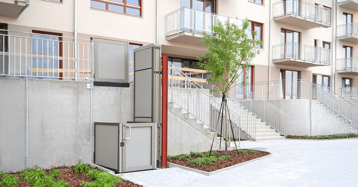 Garaventa OPAL unenclosed vertical platform lift at outdoor building entrance