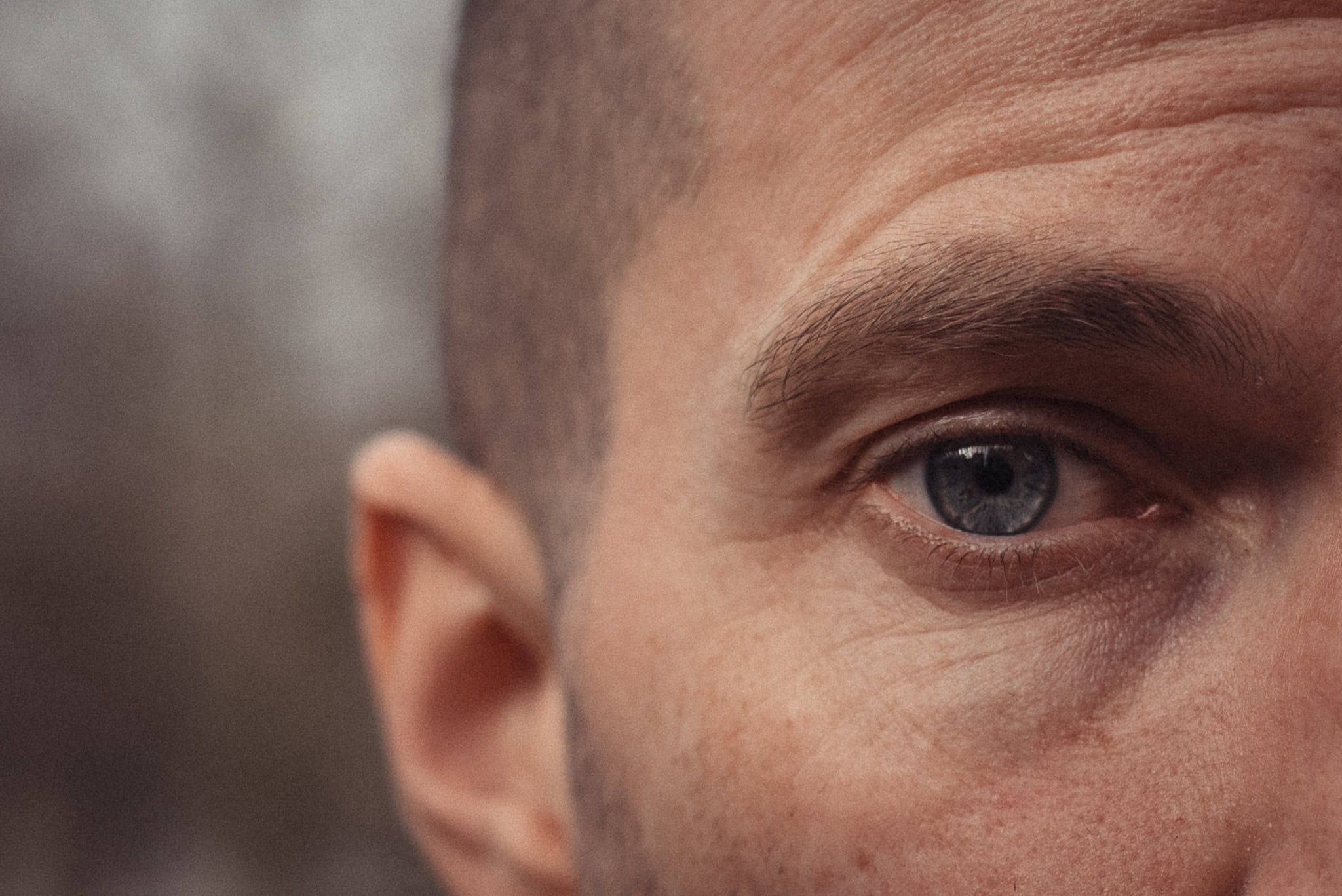 Close-up of a man's blue eye, with soft light highlighting his features. London brand photographer Phil Askew's work.
