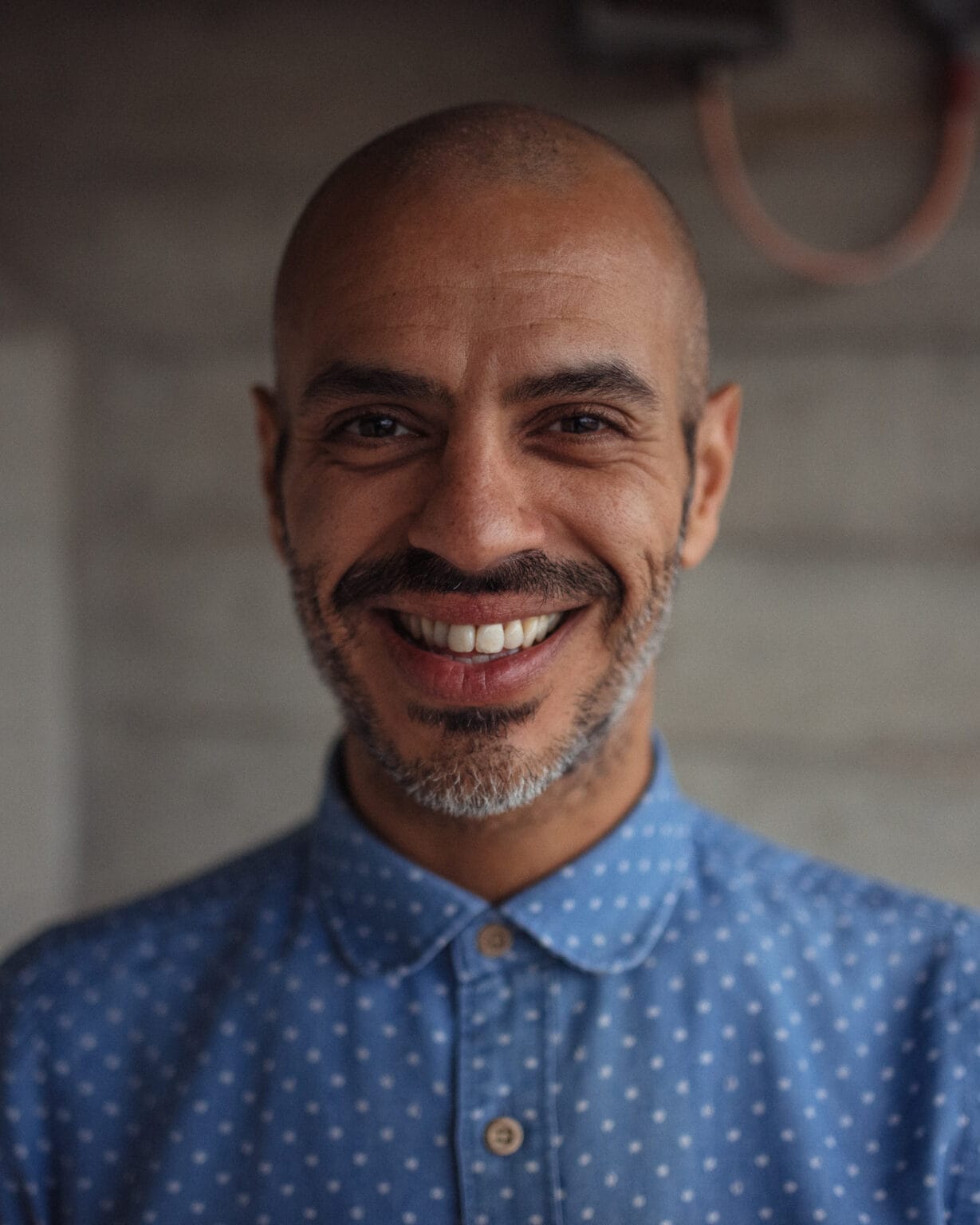 Cahit Ali, a coach, with a confident, authentic presence, captured in natural light by a London brand photographer.