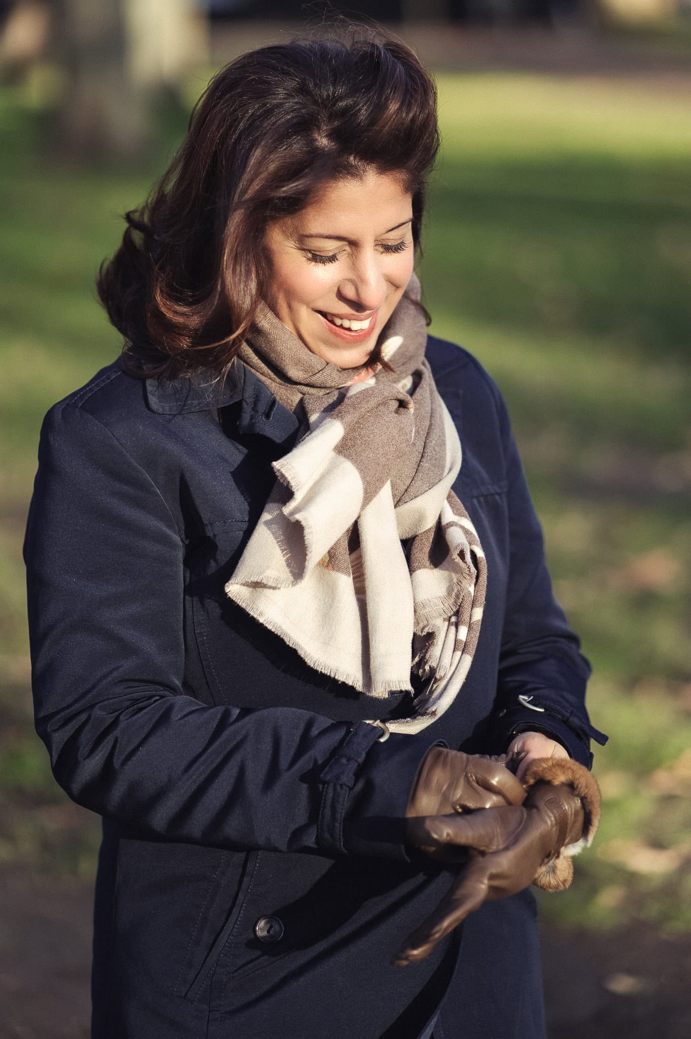 Eleonora Chessa, a confident woman, smiles warmly in natural light, a London brand photographer's focus.