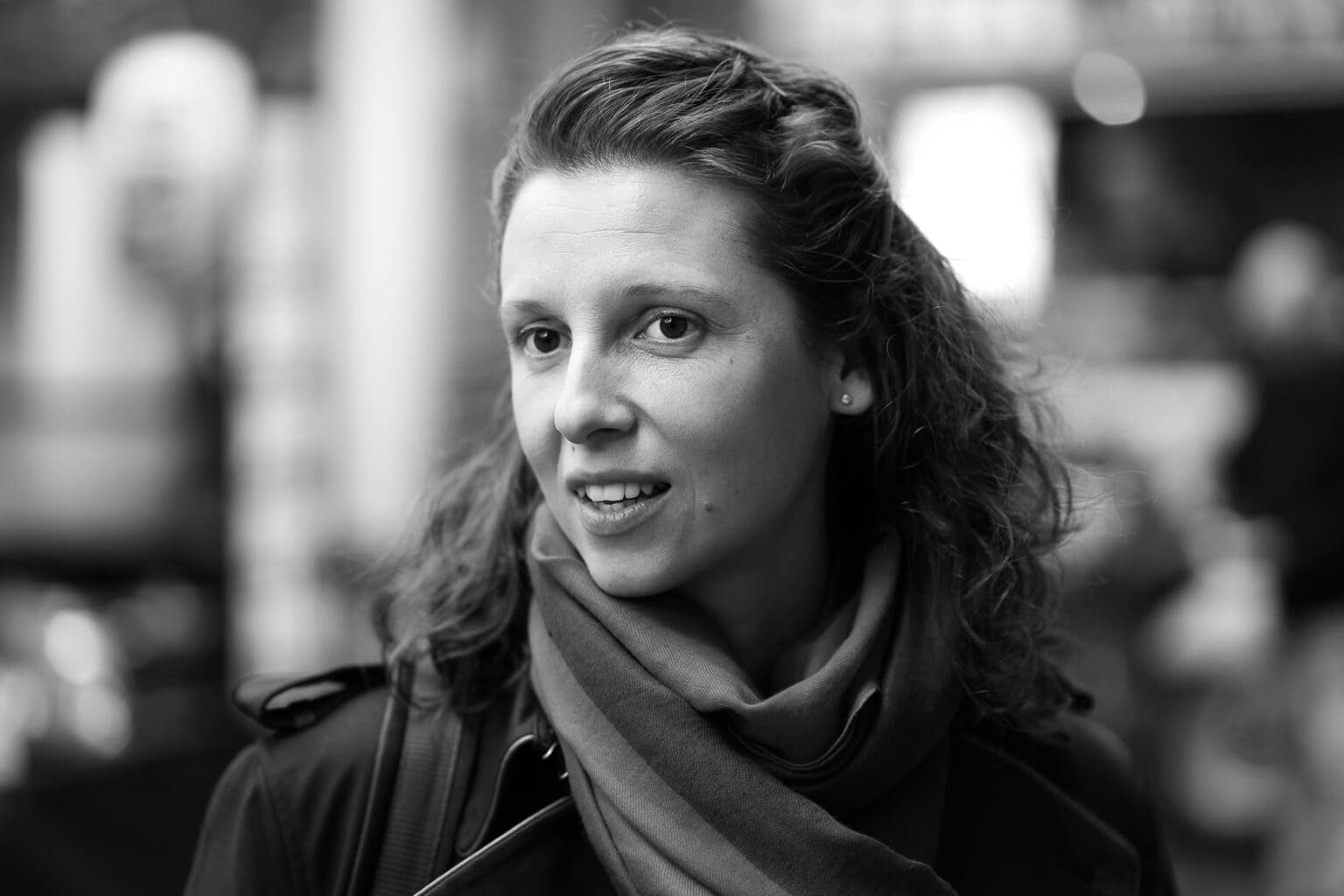 Moni Soos, a confident woman with a warm smile, photographed in London by a brand photographer.
