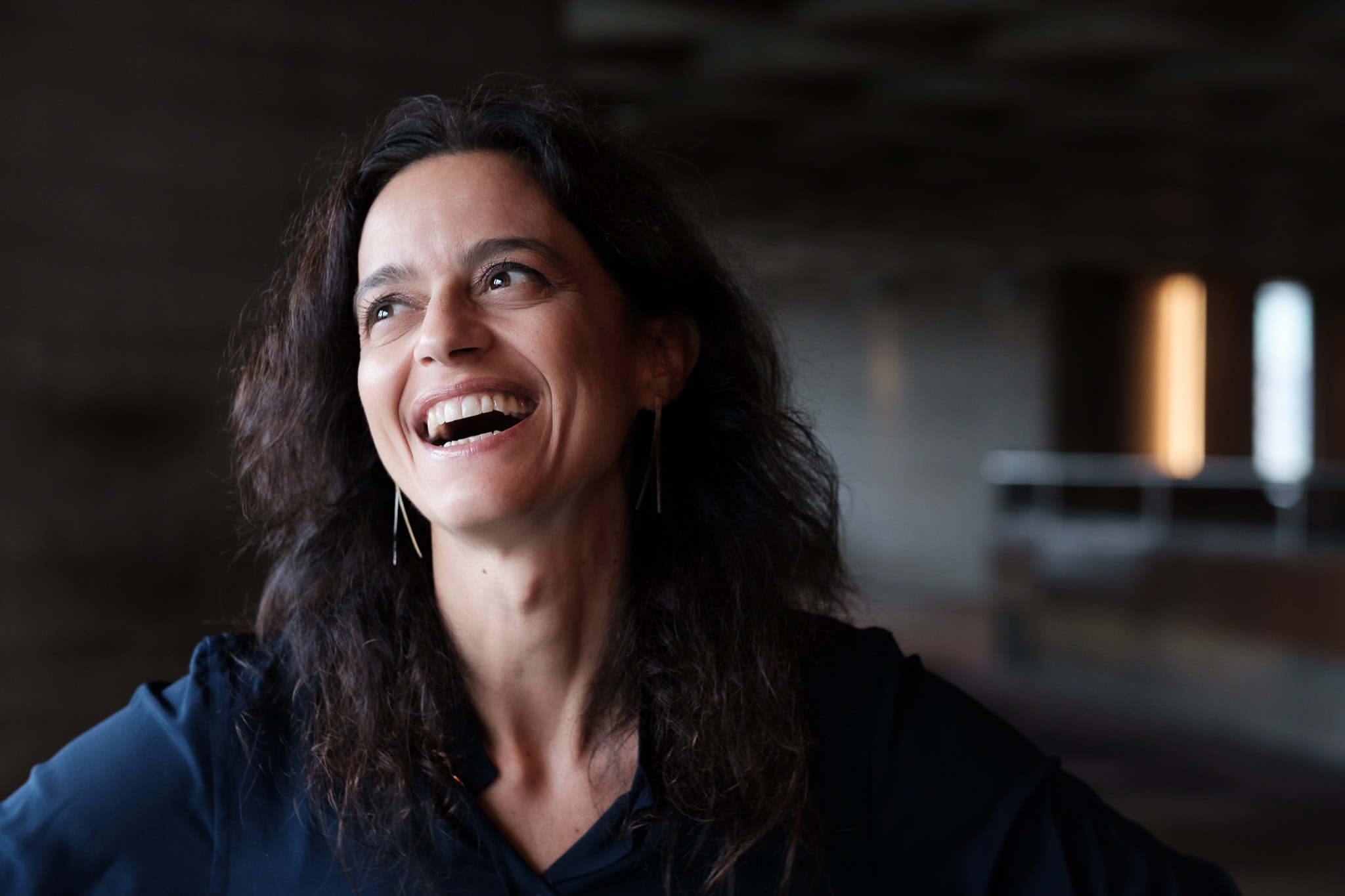 Vittoria Zipoli, a coach, laughs warmly in soft studio light, captured by a London brand photographer.