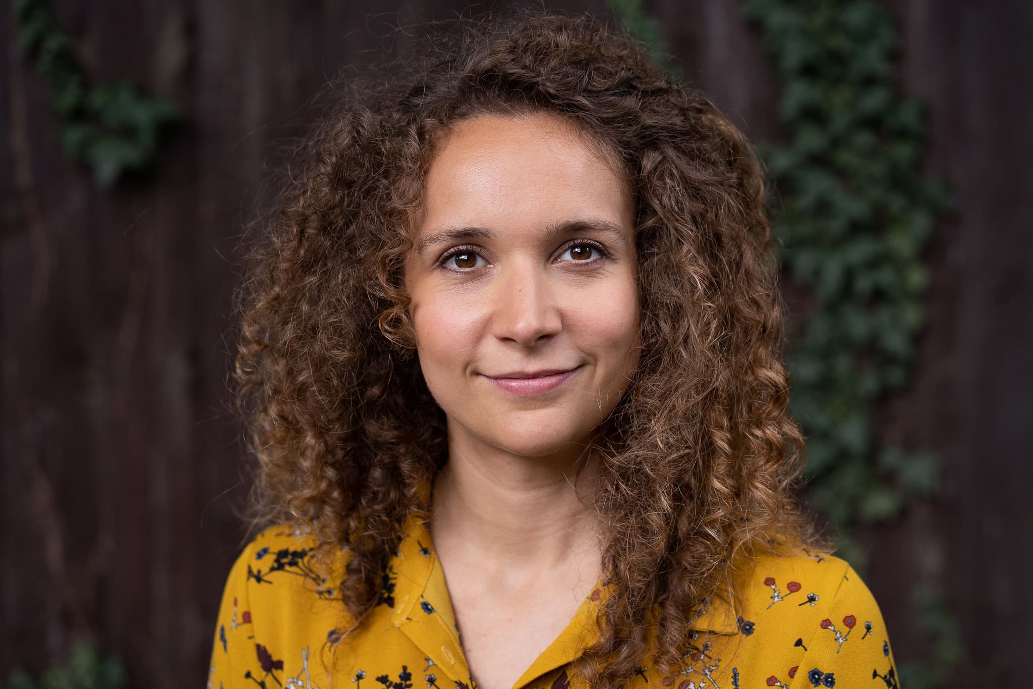 Lorraine Wilkes, a coach, in a warm London brand portrait, with soft light and a natural, confident presence.