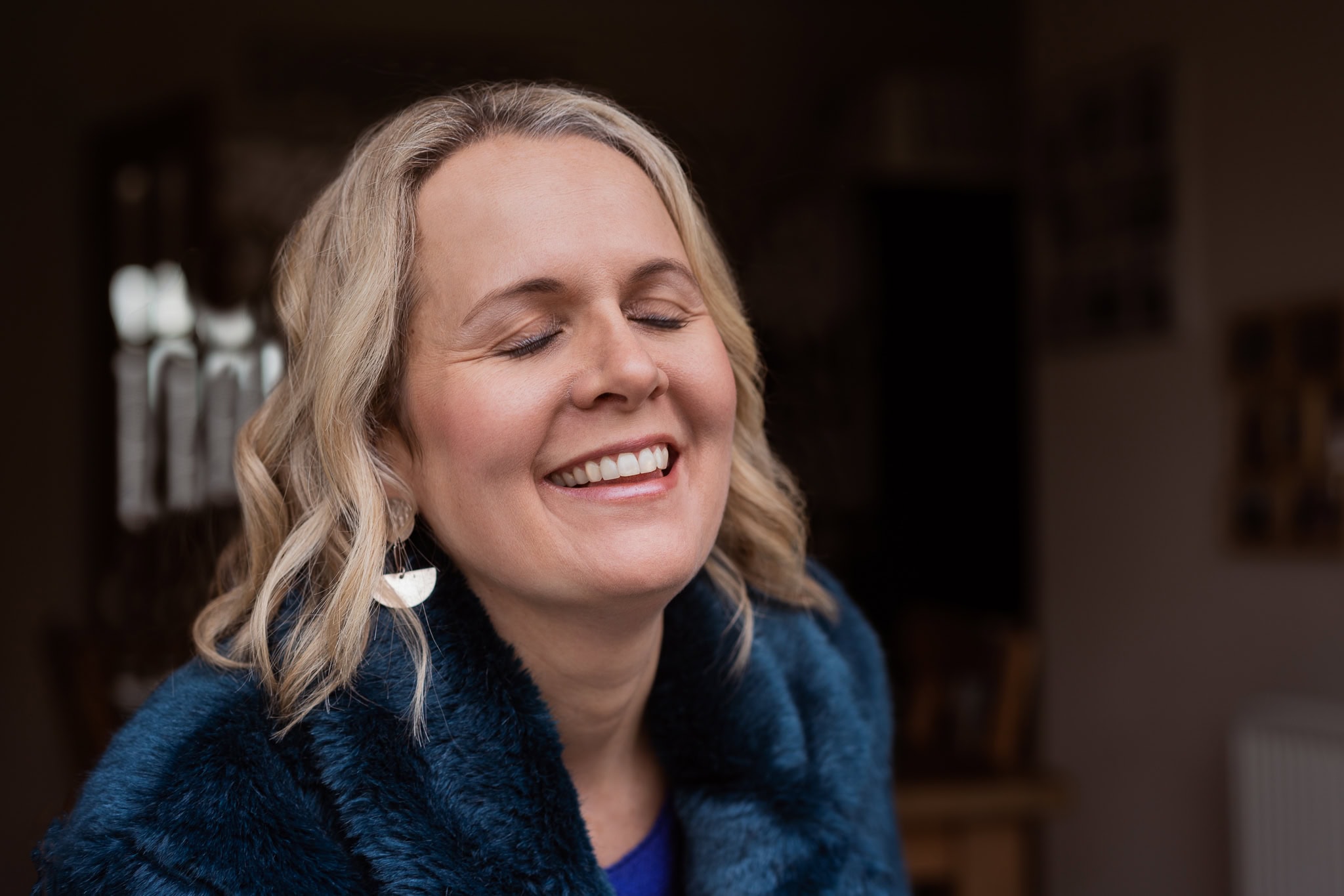 Claire Mackinnon, a coach, smiles warmly in this London brand photography portrait.