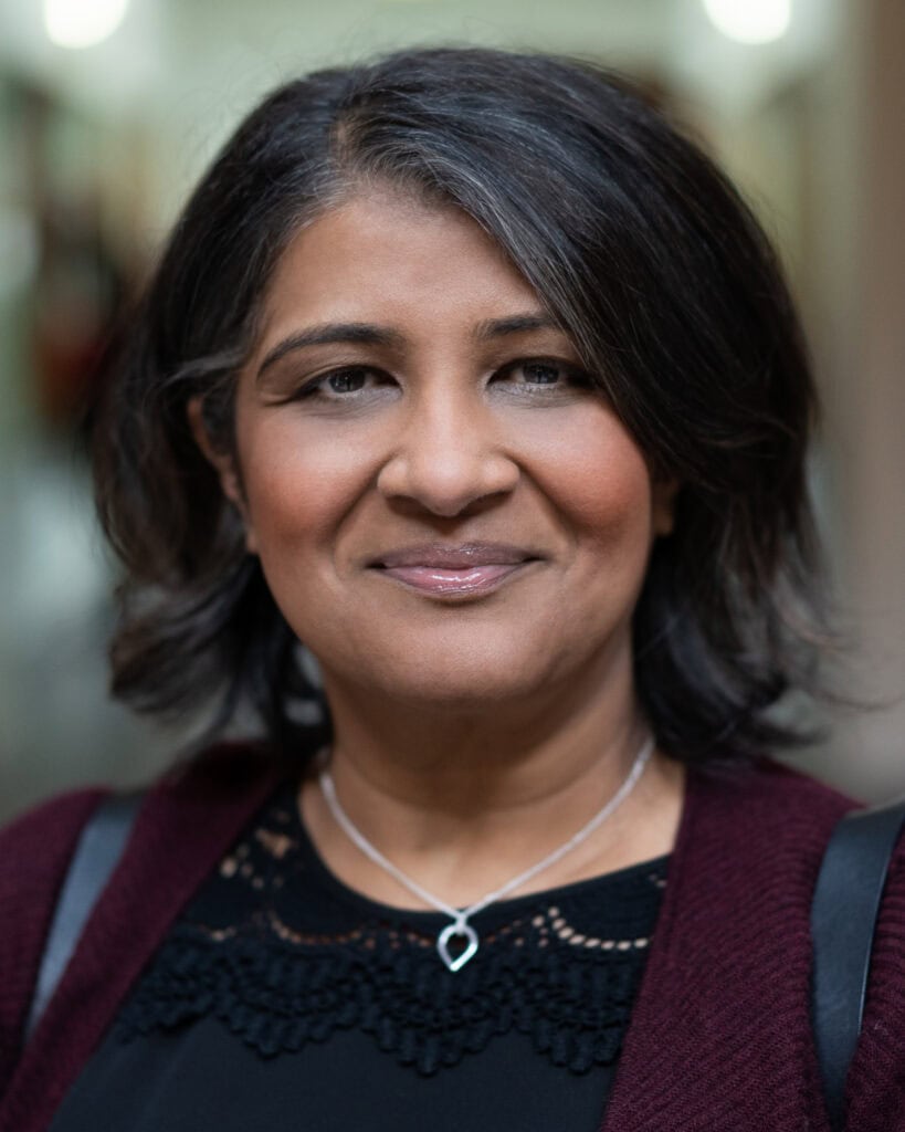 Anita Patel, a confident and authentic leader, photographed with soft natural light in London by a brand photographer.