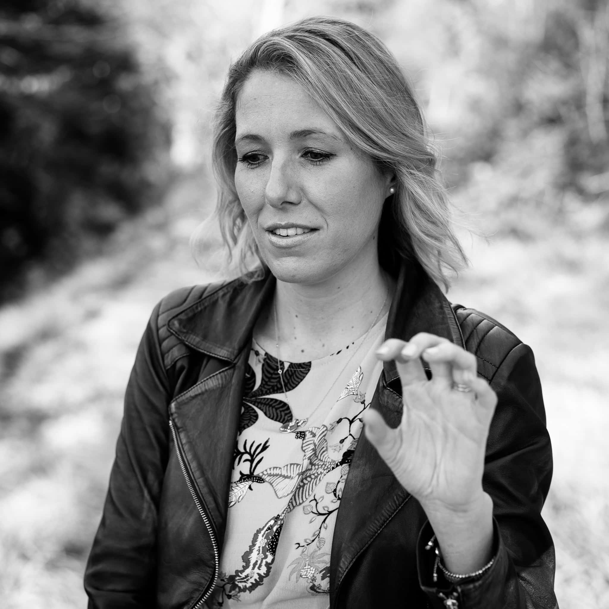 Jo Garside, London brand photographer, in a natural outdoor setting, her authentic presence captured in soft light.