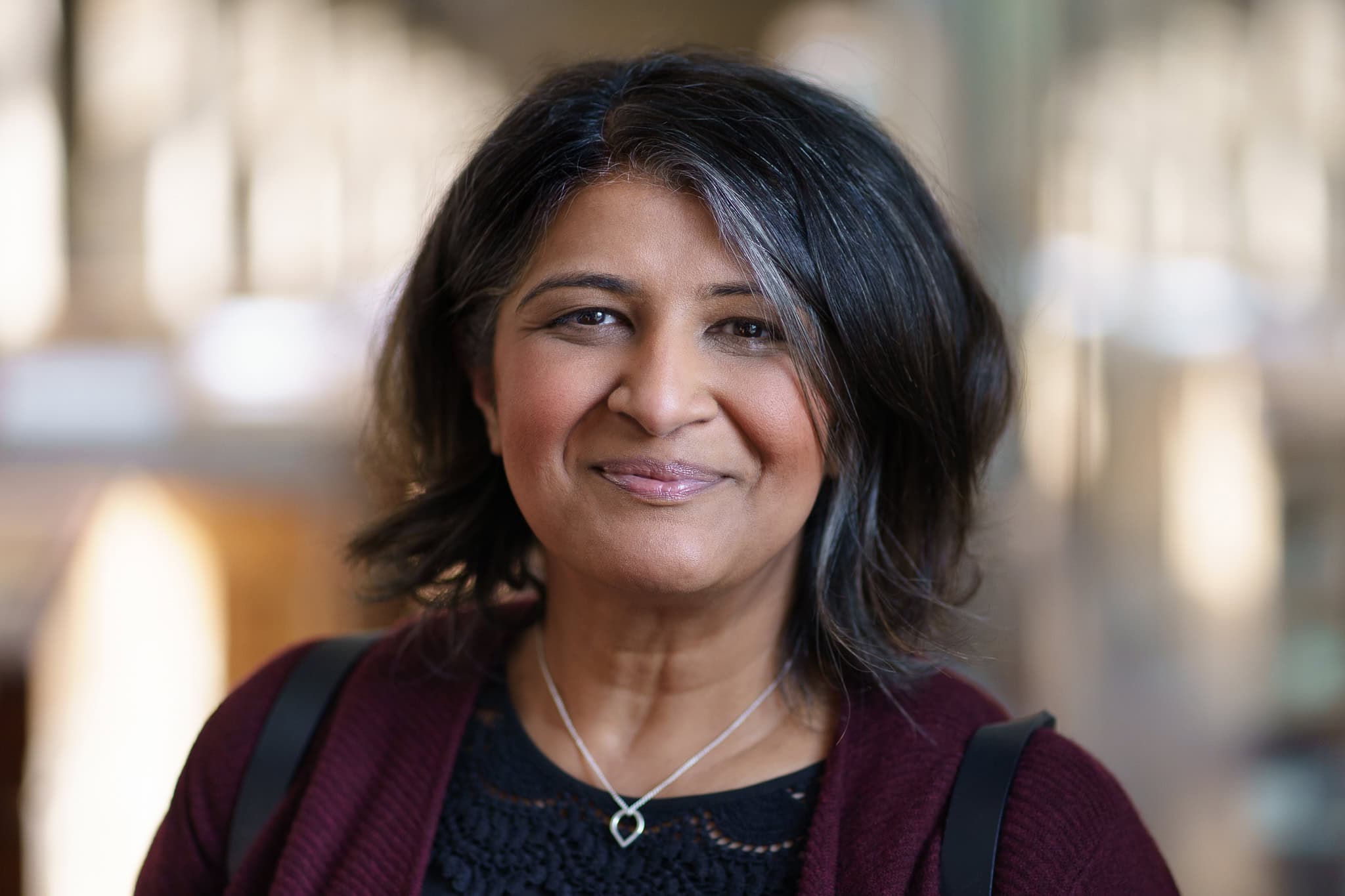 Anita Patel, a confident and authentic presence, captured in warm, natural light by a London brand photographer.