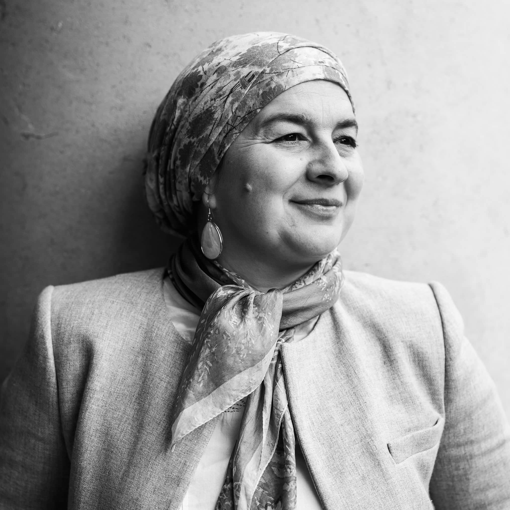 Phil Askew, London brand photographer, captures a confident woman in a story portrait, her authentic presence illuminated.