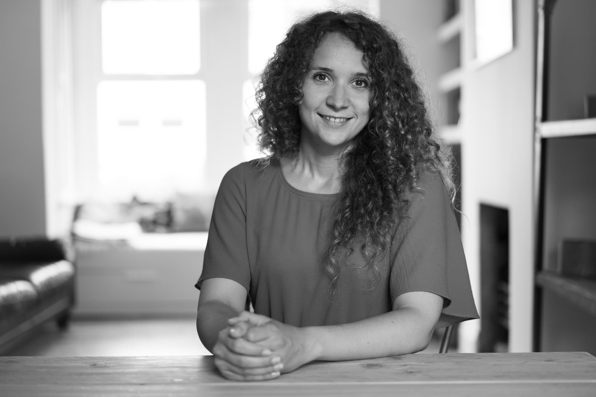 Lorraine Wilkes, a coach, beams confidently in a London studio, captured by a brand photographer.