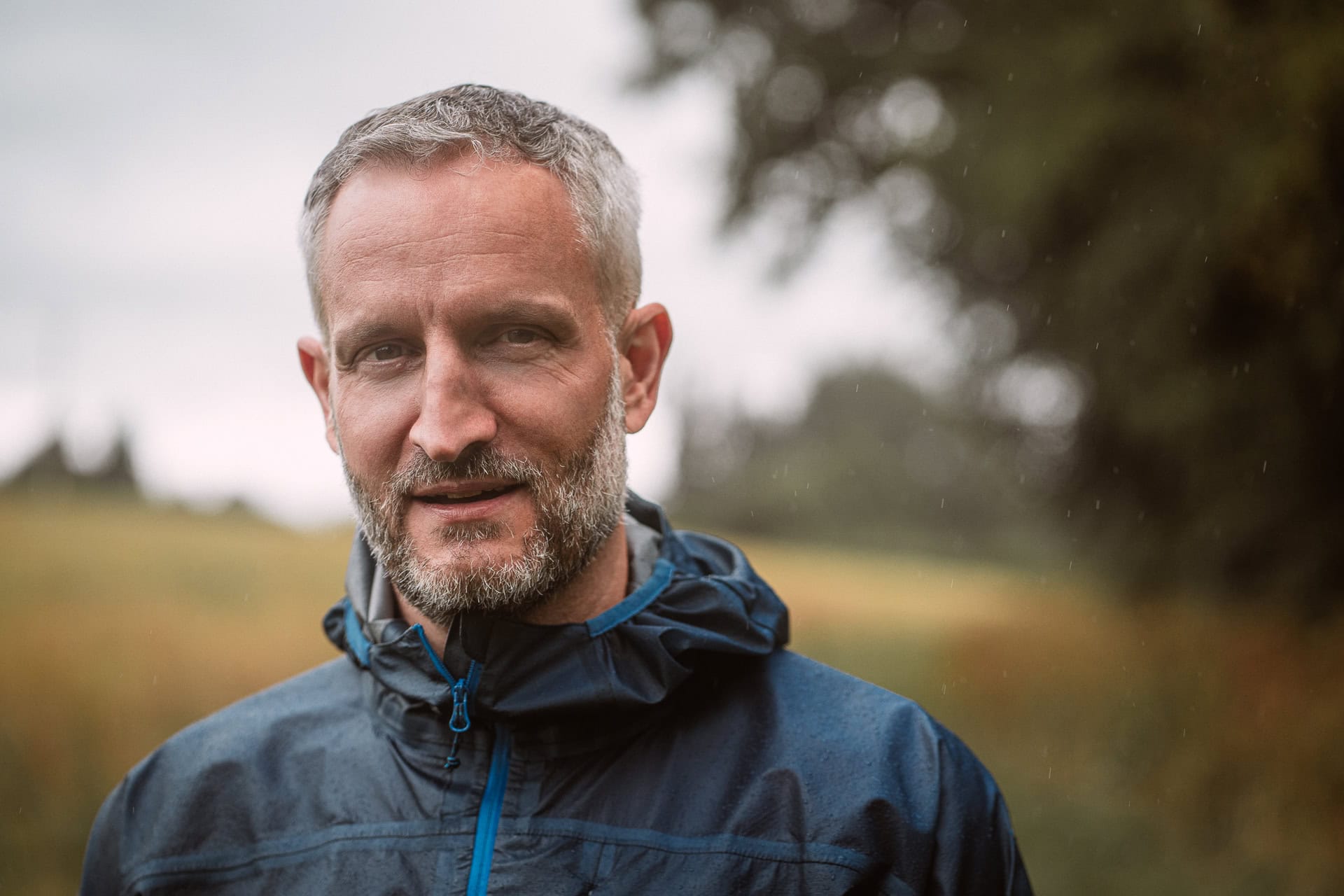 Andrew Willson, a London brand photographer, captures a confident coach headshot in natural light.