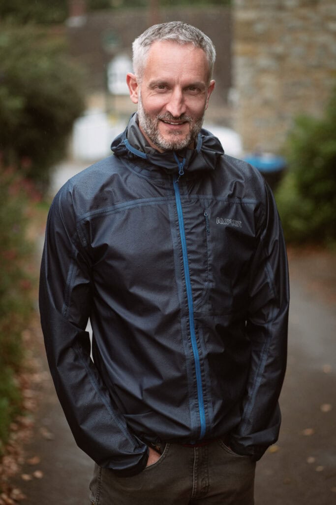 Andrew Willson, a London brand photographer's client, smiles warmly in a natural portrait.