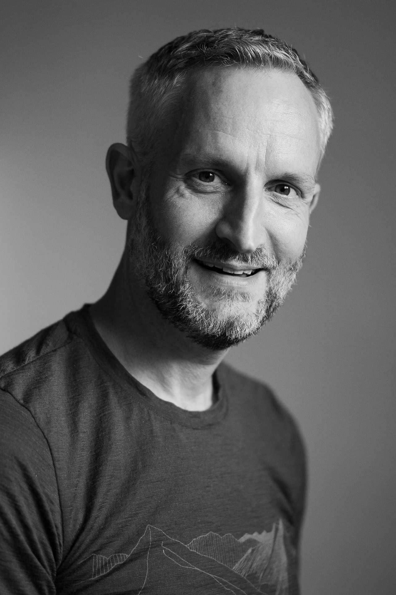 Andrew Willson, a London brand photographer, captured in a warm, authentic portrait with soft light.