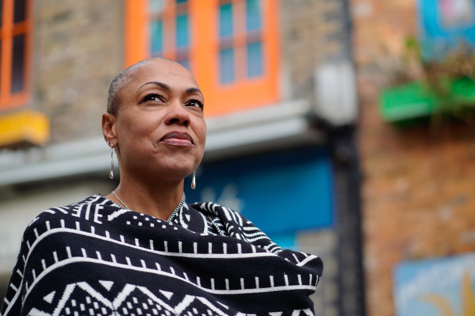 Sharlene Jones, a confident woman with a warm smile, photographed by a London brand photographer.