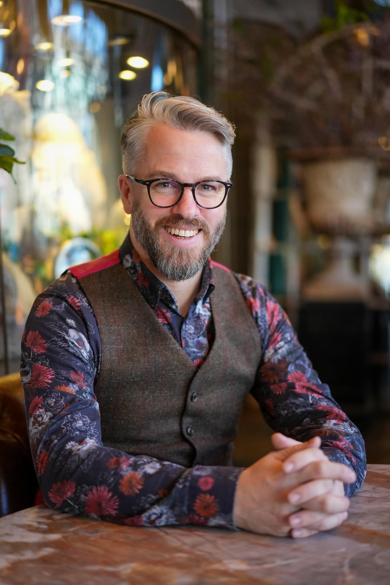 Phil Askew, London brand photographer, capturing a confident coach headshot in warm light.