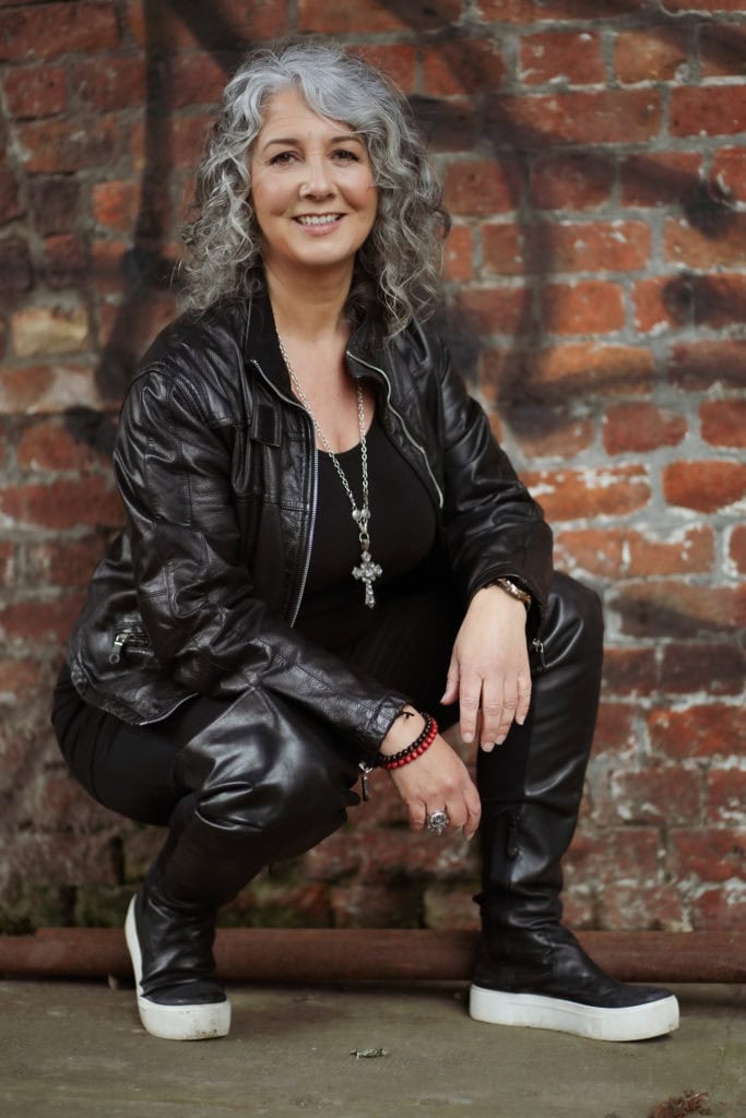 Zena Me, a confident woman in leather, photographed by a London brand photographer.