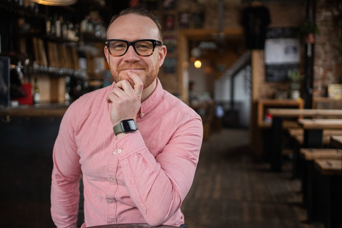 Ciaran Henderson, a London brand photographer, in a warm pub setting.
