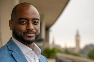 Meshach Amuah-Fuster, a confident leader, in a London brand portrait with soft light.