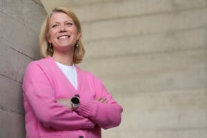 Meg Lyons, a confident leader, smiles warmly, photographed by London brand photographer Phil Askew.