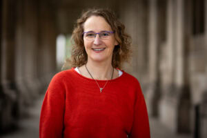 Claire Hunter, a confident leadership coach, photographed in London by a brand photographer. Warm light highlights her authentic presence.