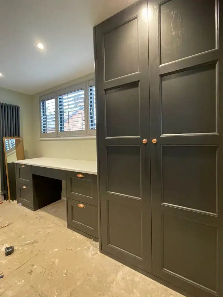 Elegant custom-made dark wardrobe and dressing table, crafted by Made 2 Measure Interiors.