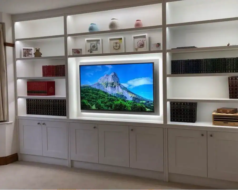 Built-in white custom-made storage with integrated TV cabinet, perfect for contemporary home interiors.