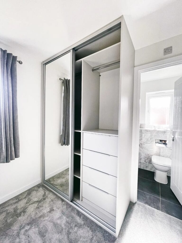 Custom built-in wardrobe with sliding mirror doors for stylish can maximise storage space.