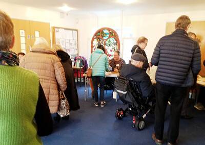 People gathering at Oriana Choir Macclesfield event, community choir members and attendees.