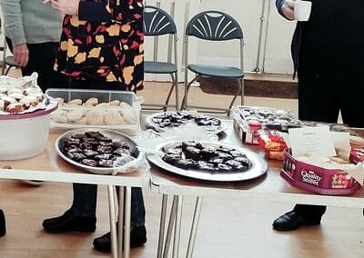 Tasty homemade baked goods served at Macclesfield Oriana Choir fundraiser event in a community hall.