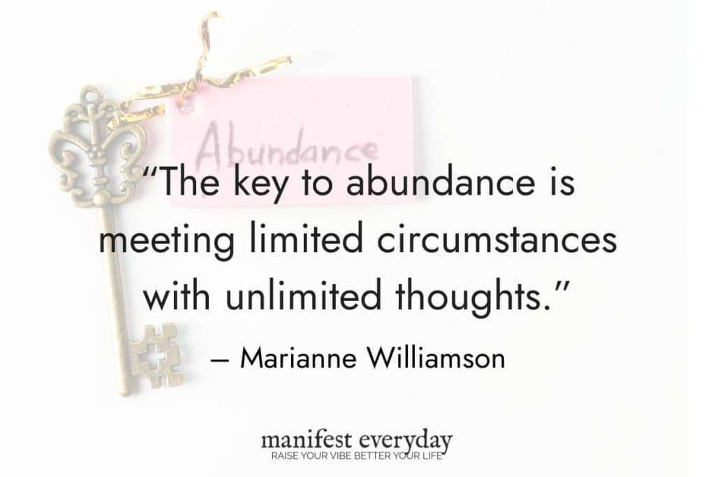 an antique gold key with pink note attached to it that says abundance with quote text that reads “The key to abundance is meeting limited circumstances with unlimited thoughts.” – Marianne Williamson manifesteveryday.com