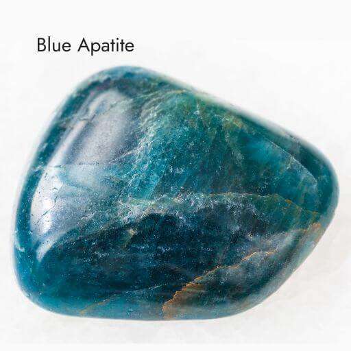 smooth polished blue apatite crystal with white background
