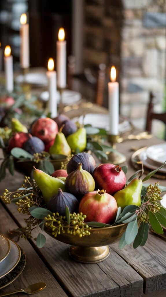 Fall wedding table decorated with figs, pomegranates, pears, and warm seasonal greenery