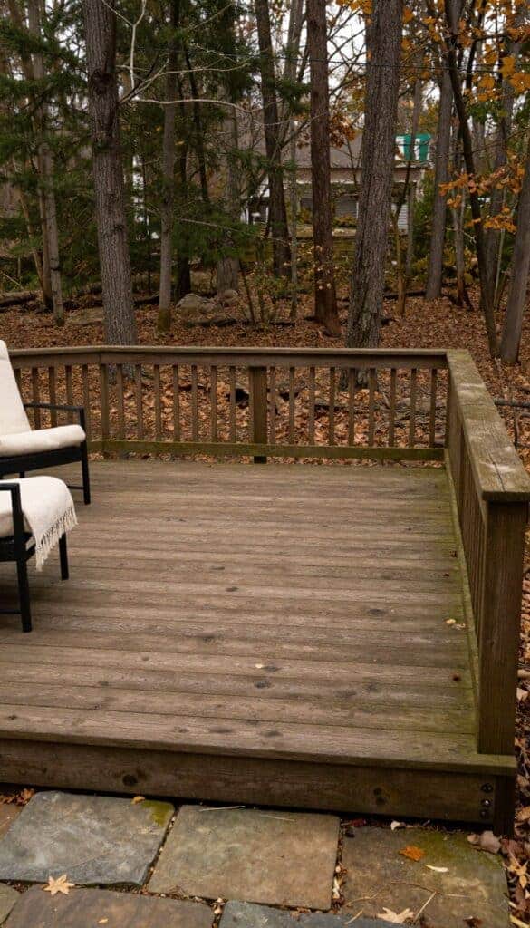 Earthy olive-brown deck stain in a wooded backyard