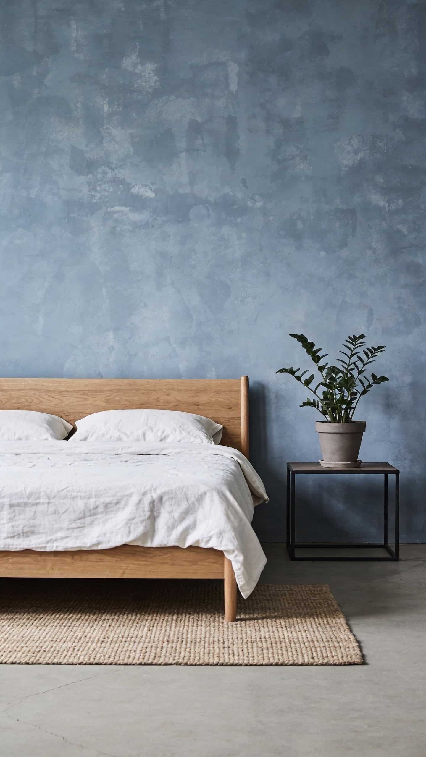 blue-grey limewash wall in a calm bedroom
