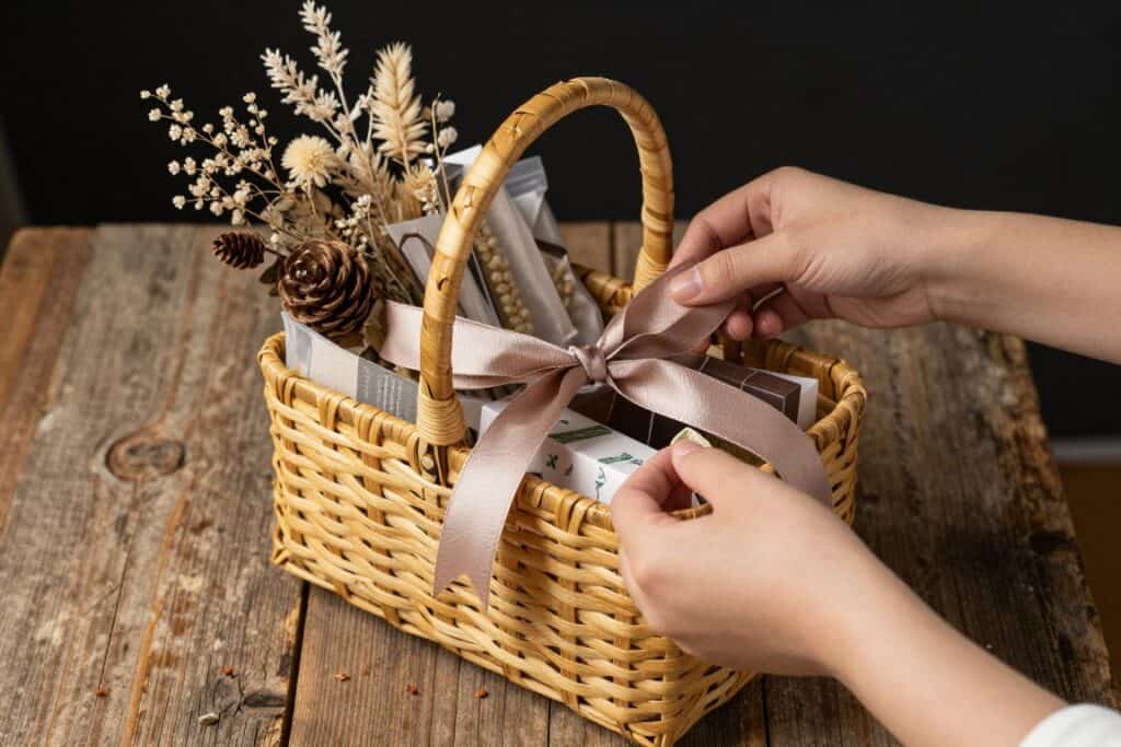 Curating thoughtful items for a bespoke hamper on a rustic wooden table