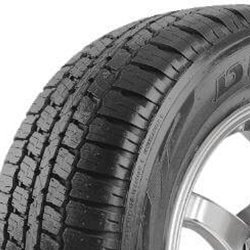 Close-up of a durable truck tire with deep tread pattern for heavy-duty use.