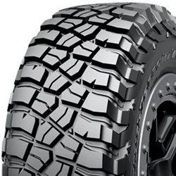 Off-road tire with rugged tread pattern for heavy-duty vehicles.