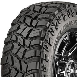 Off-road tire with rugged tread pattern for heavy-duty vehicles.