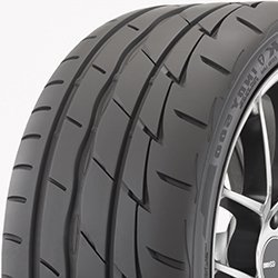 Close-up of a Firestone Firehawk Indy 500 summer tire on a car wheel.