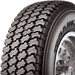 Close-up of a rugged tire with deep treads for heavy-duty vehicles.