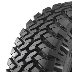 Off-road tire with deep tread for rugged terrain.