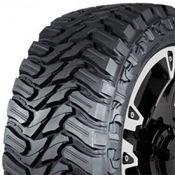 Off-road tire with aggressive tread pattern for rugged terrain.